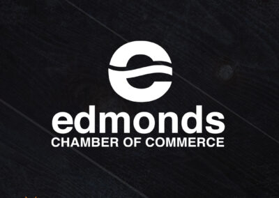 A bold and vibrant logo for the Edmonds Chamber of Commerce, rebranded by Giant Punch, a full-service branding and design agency. The logo features a lowercase "e" in the shape of a sun and water, with a fun new color palette.