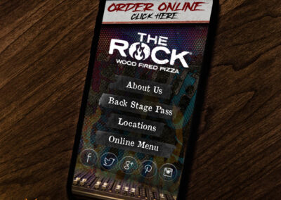Mobile website with a grunge background showcasing delicious pizza from Rock Wood Fired Pizza.