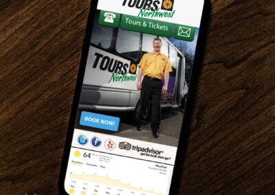 iPhone displaying Tours Northwest's scenic tour guide in front of a tour bus.